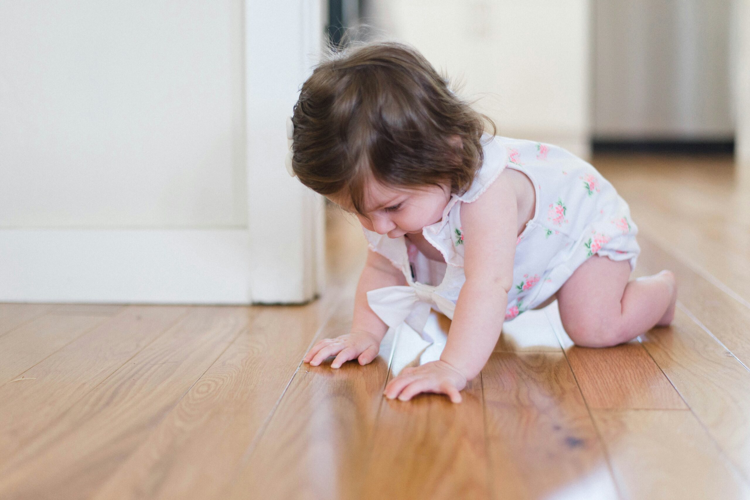 toddler crawling on a clean hardwood floor